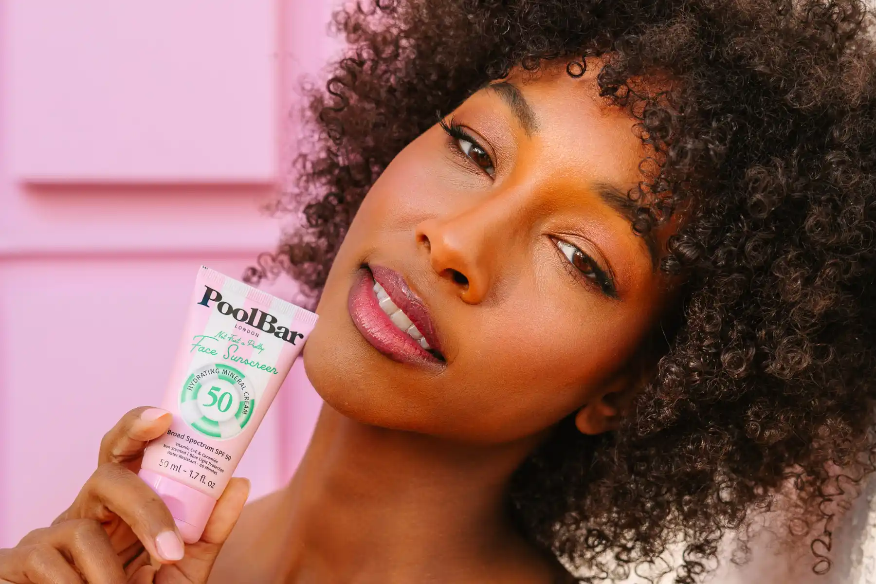 Close up of woman holding PoolBar Sunscreen