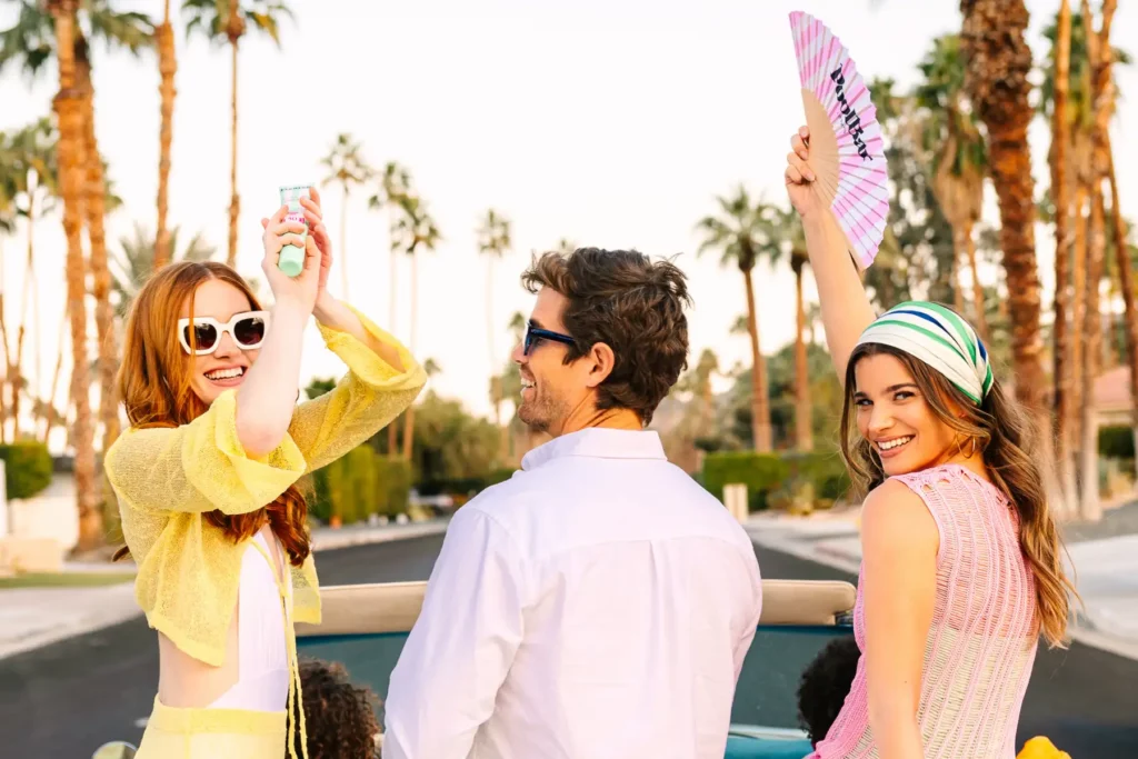 Three people in summer wear smiling