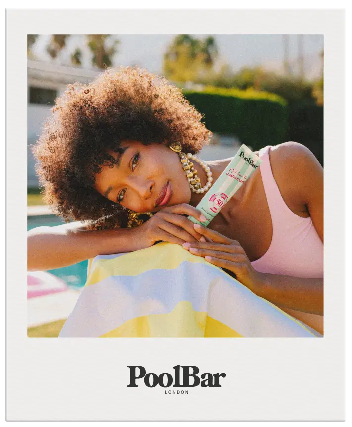 polaroid of woman holding spf 50 sunscreen