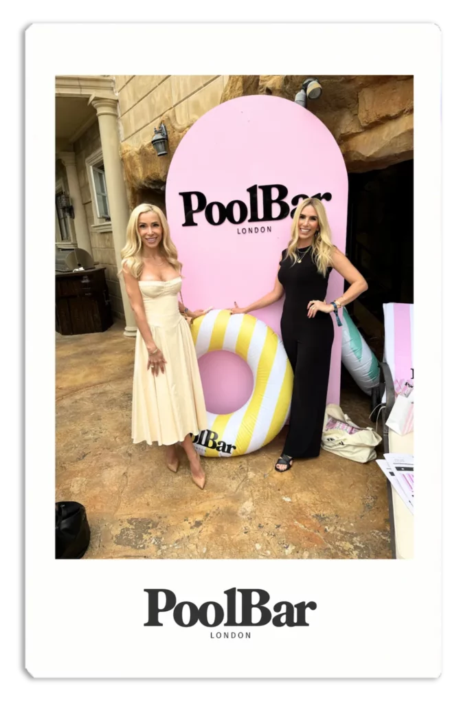 2 blonde women smiling with poolbar branded yellow and white striped rubber ring pool float polaroid