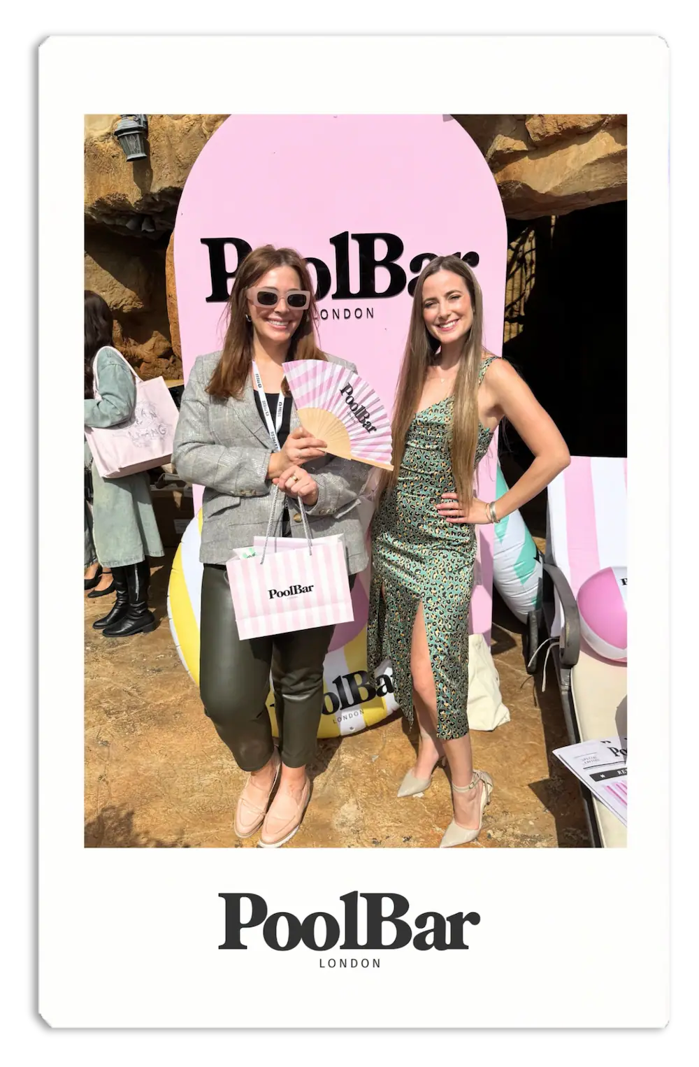 woman in green leopard print dress and woman in blazer posing for camera