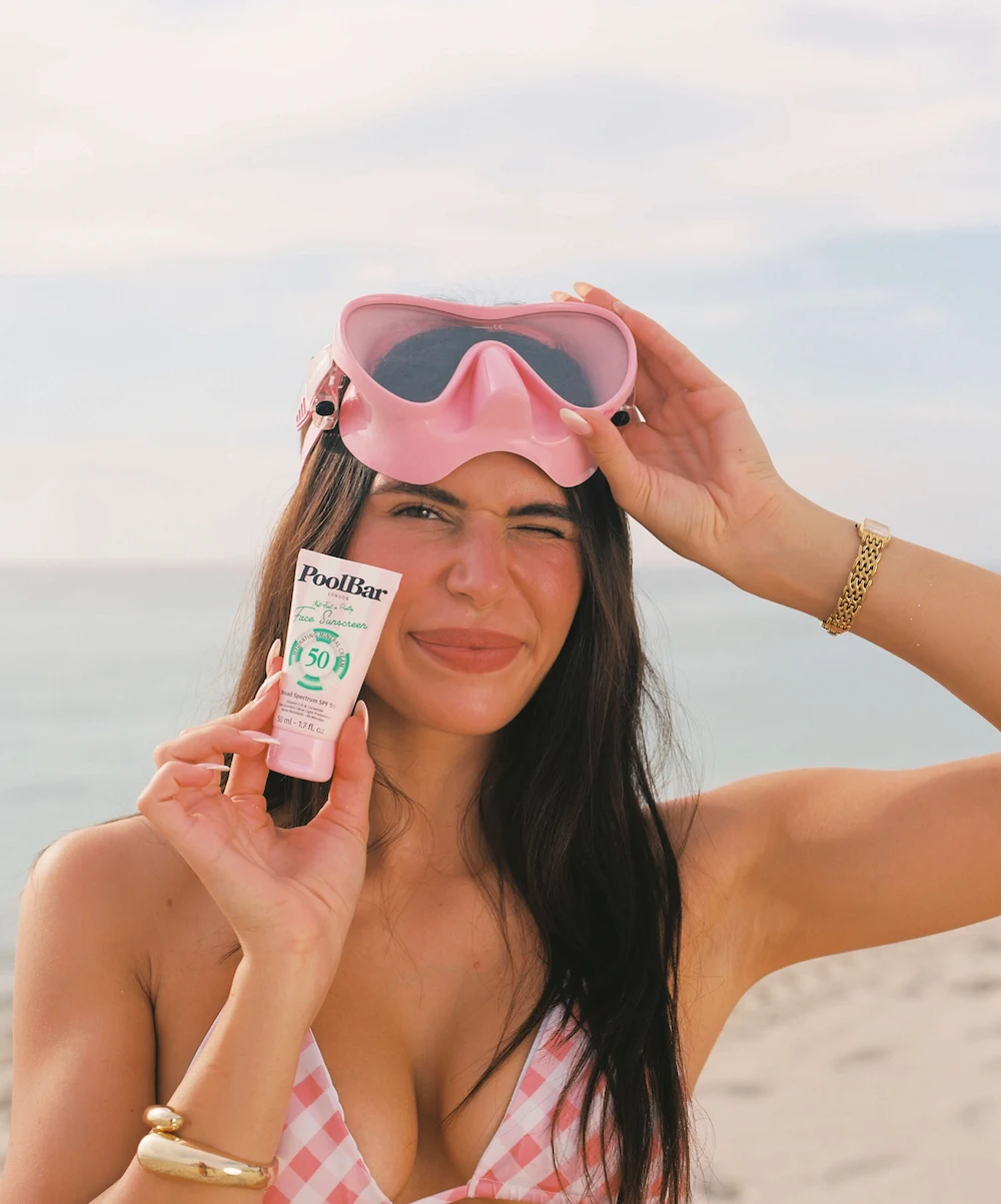 woman holding face spf50 poolbar