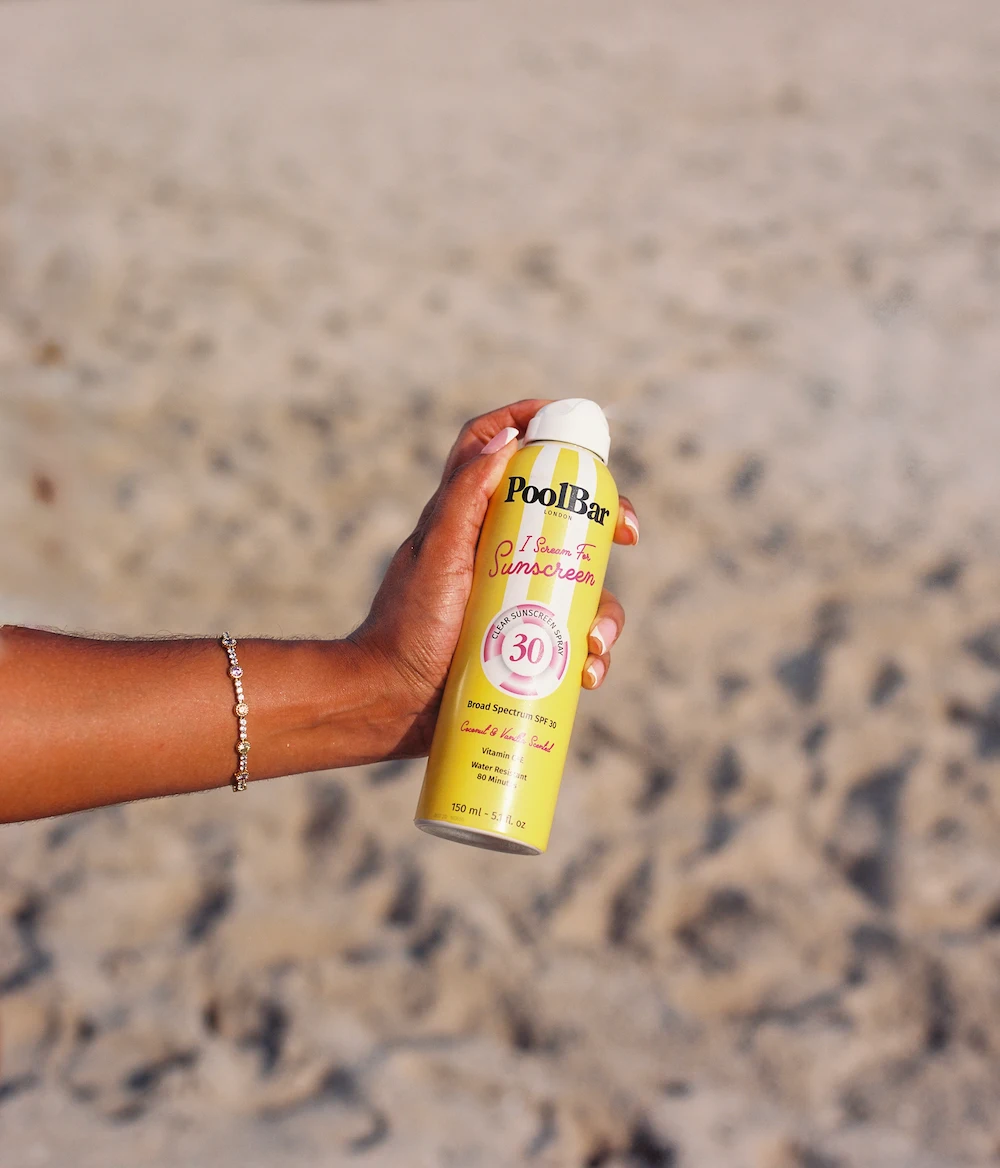 holding poolbar spf 30 sunscreen spray