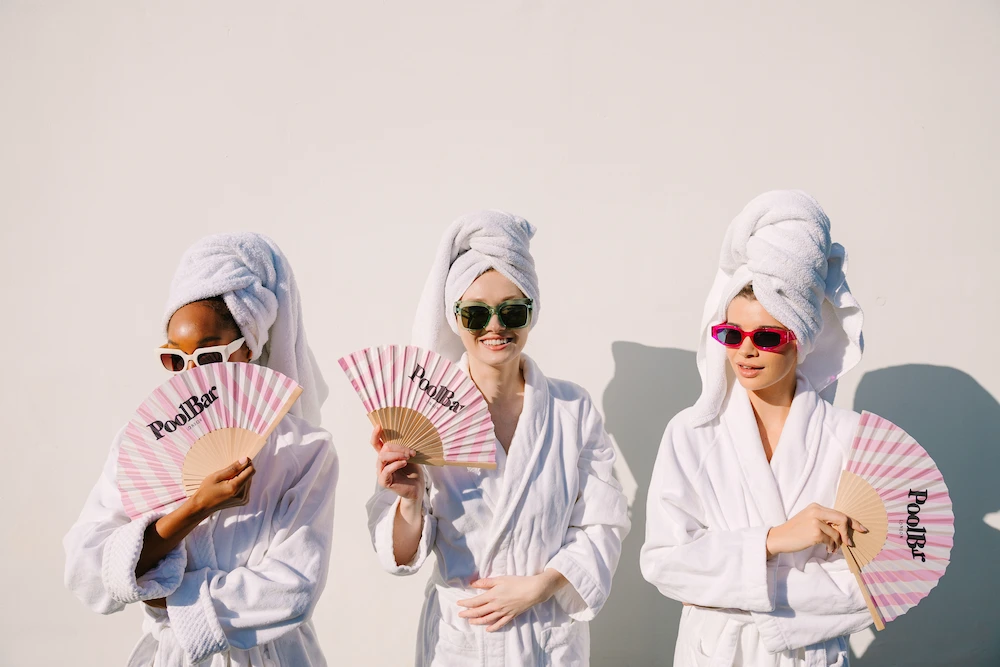 are mineral sunscreens safe for pregnancy, 3 models in dressing gowns and towels posing with poolbar fans